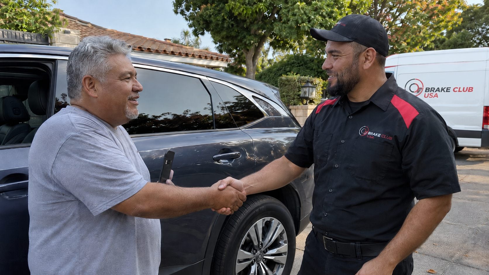 Brake Club USA technician shaking hands with a satisfied customer after completing on-site brake service